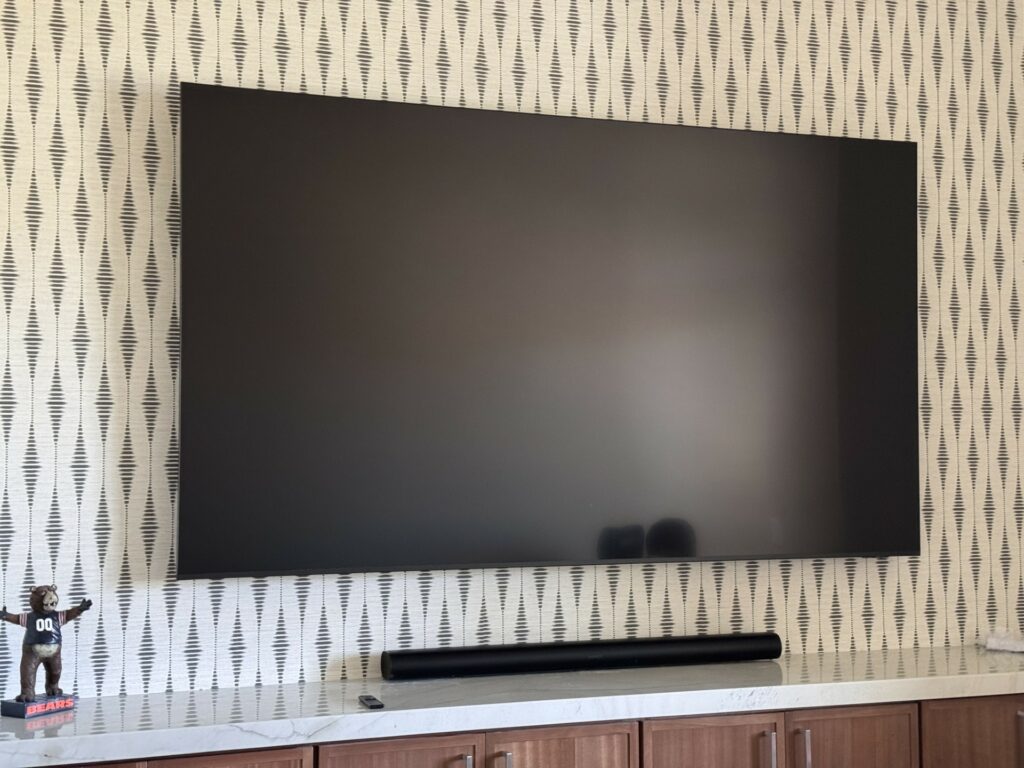 Wall-mounted TV and soundbar in a custom home theater