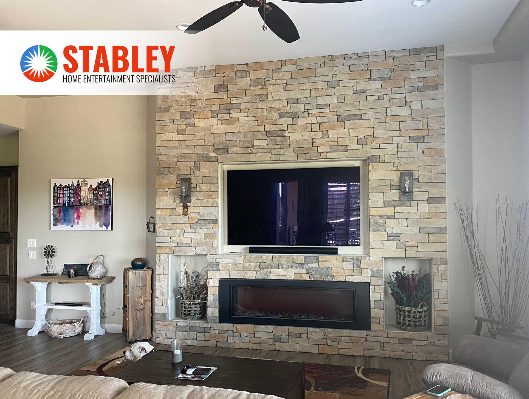 Stabley home entertainment installation with a wall-mounted TV and fireplace